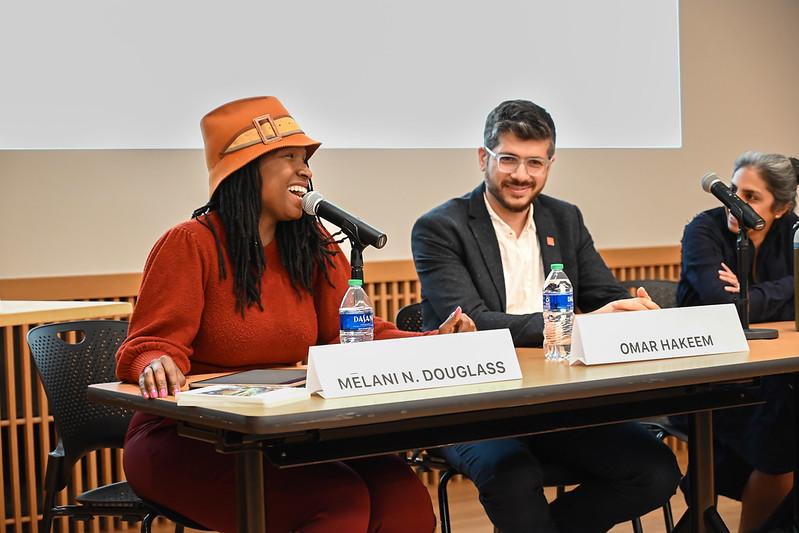 Woman with a hat laughing during her panel