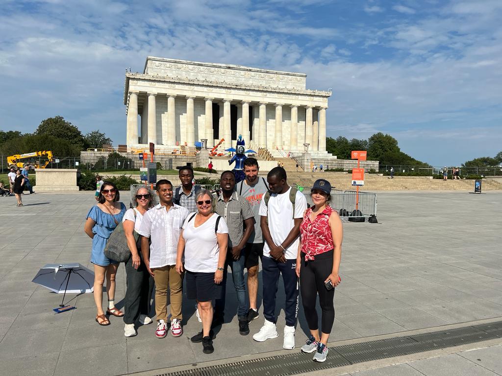 Faculty and students posing in front of the Lincoln Memorial.