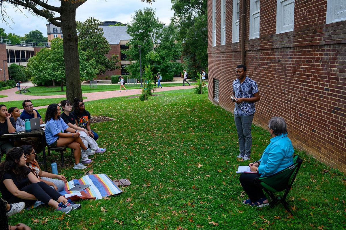 Michel Cabral Mandela Fellow speaking to students outside