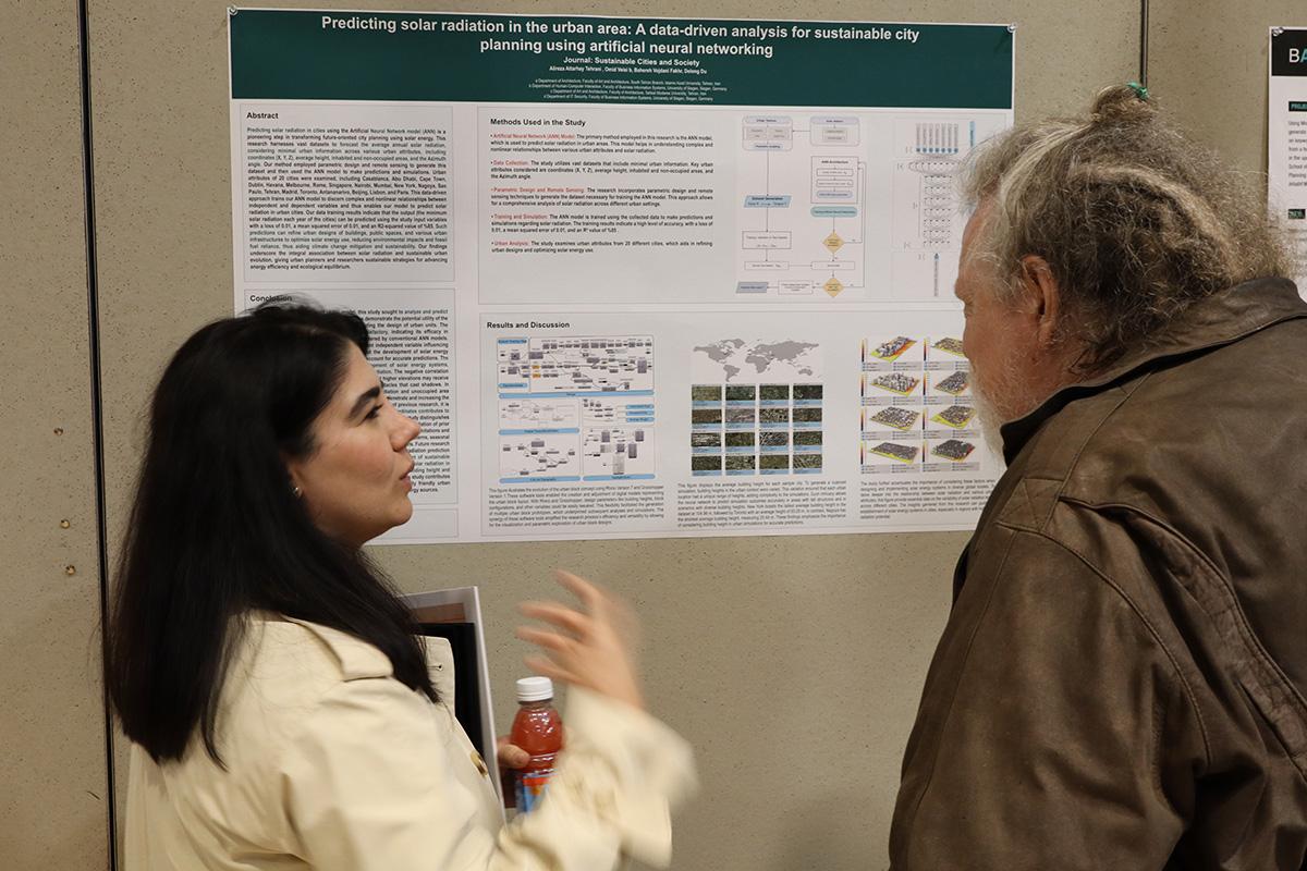 A student presenting her poster