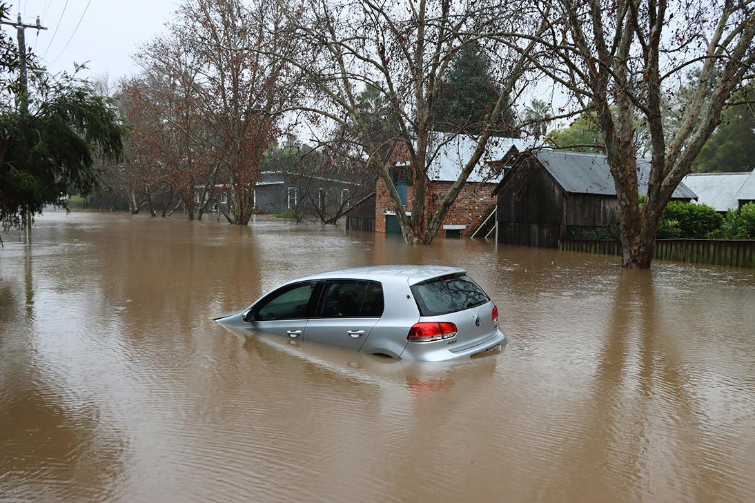 A car flooding in brown murky water