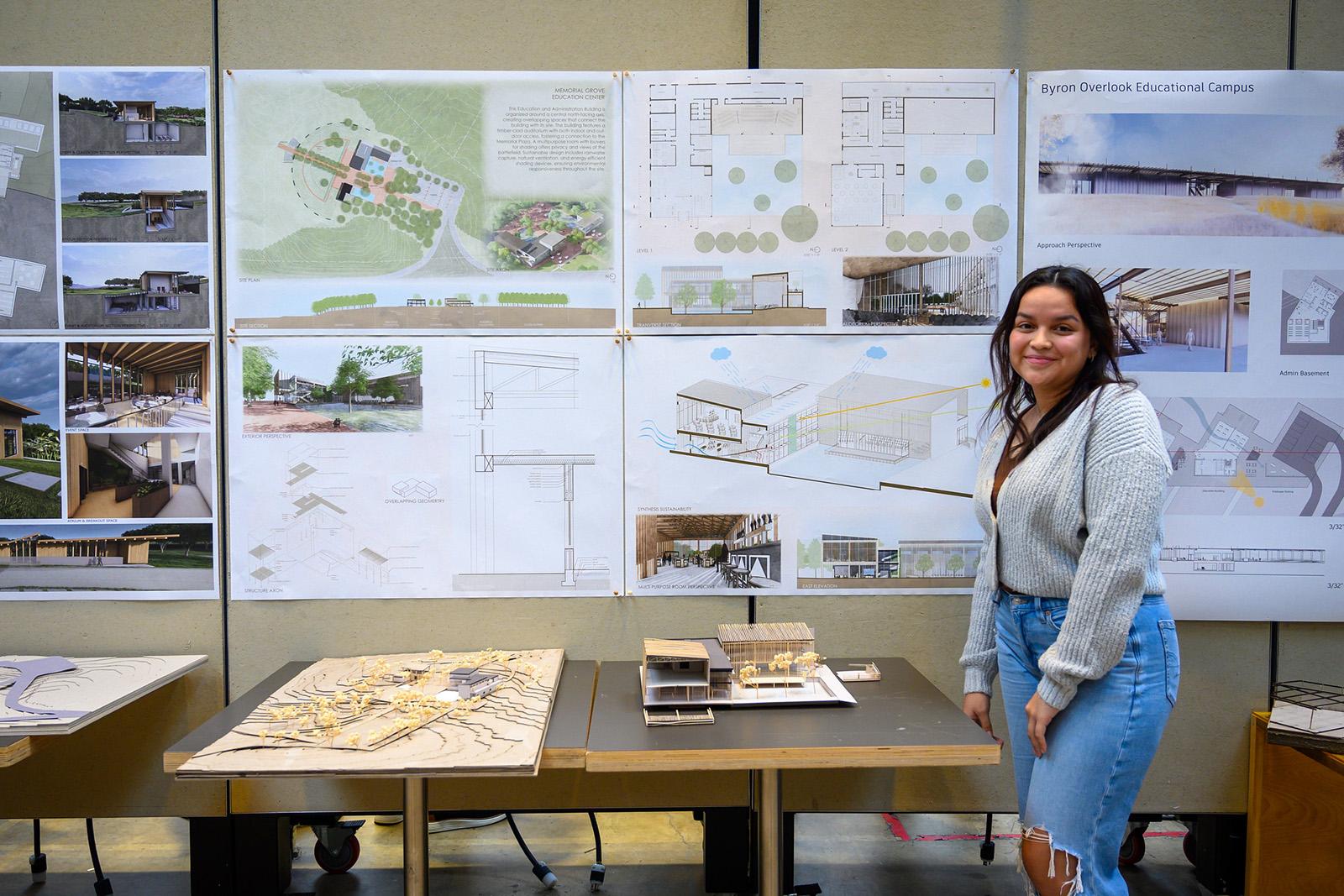 Student standing in front of her pinup and 3D models