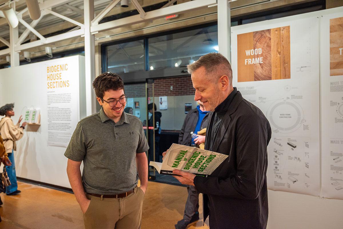 Student getting his book signed during a gallery exhibit