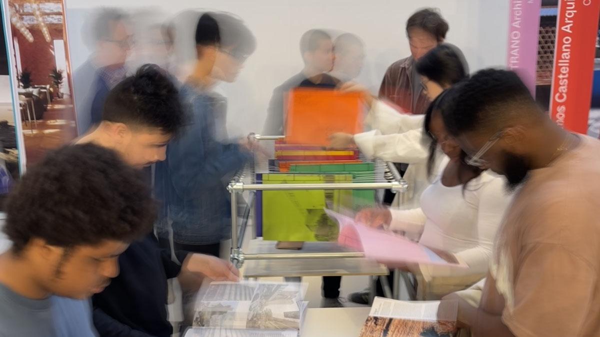 Slow shutter of people looking through magazines