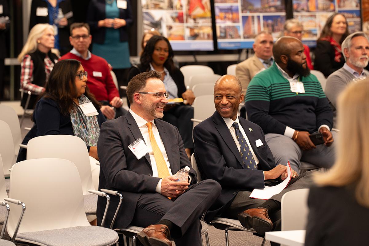 Jason Sartori and Artie Harris smiling in a crowd.