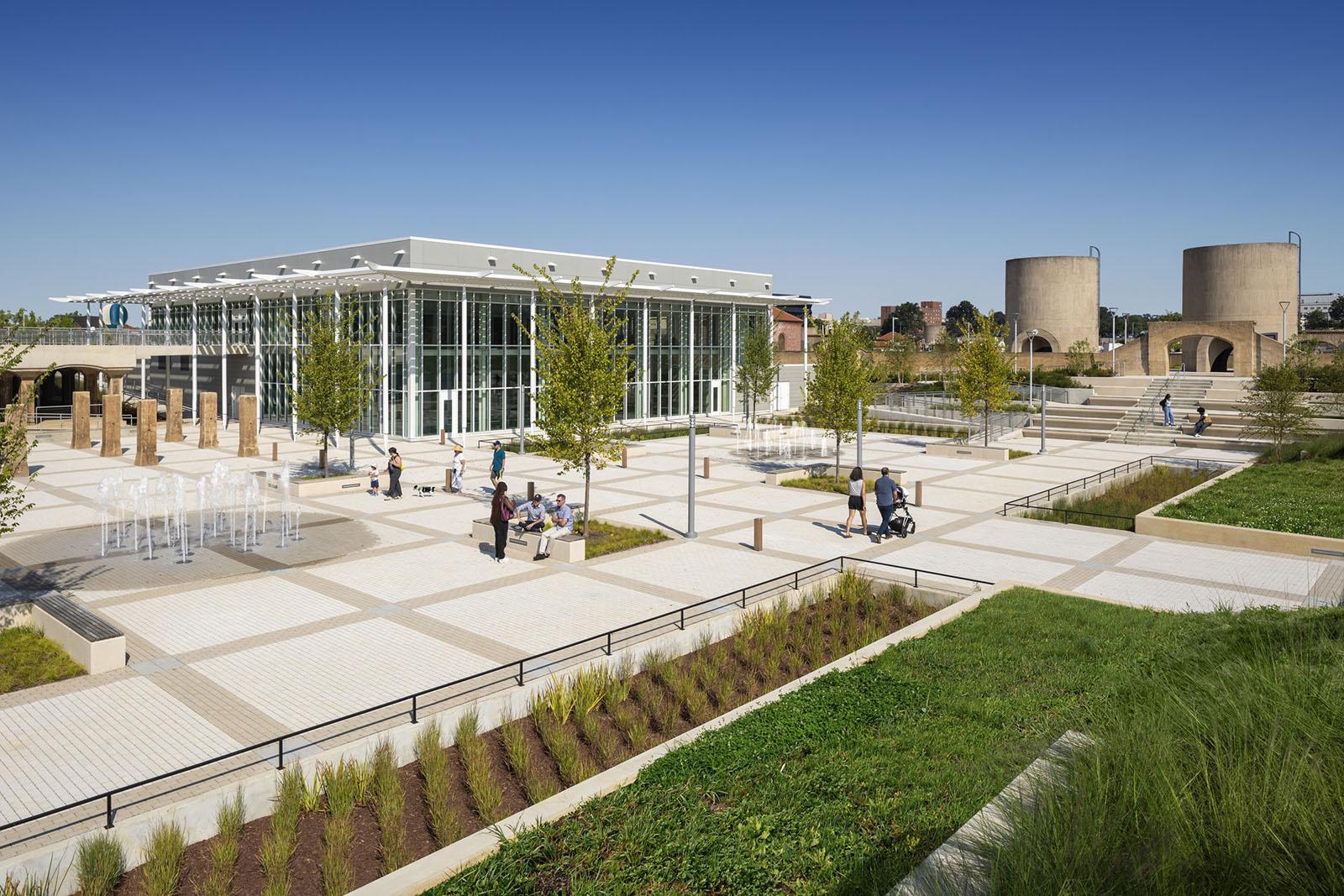 Exterior of the community center with cisterns in the background. 