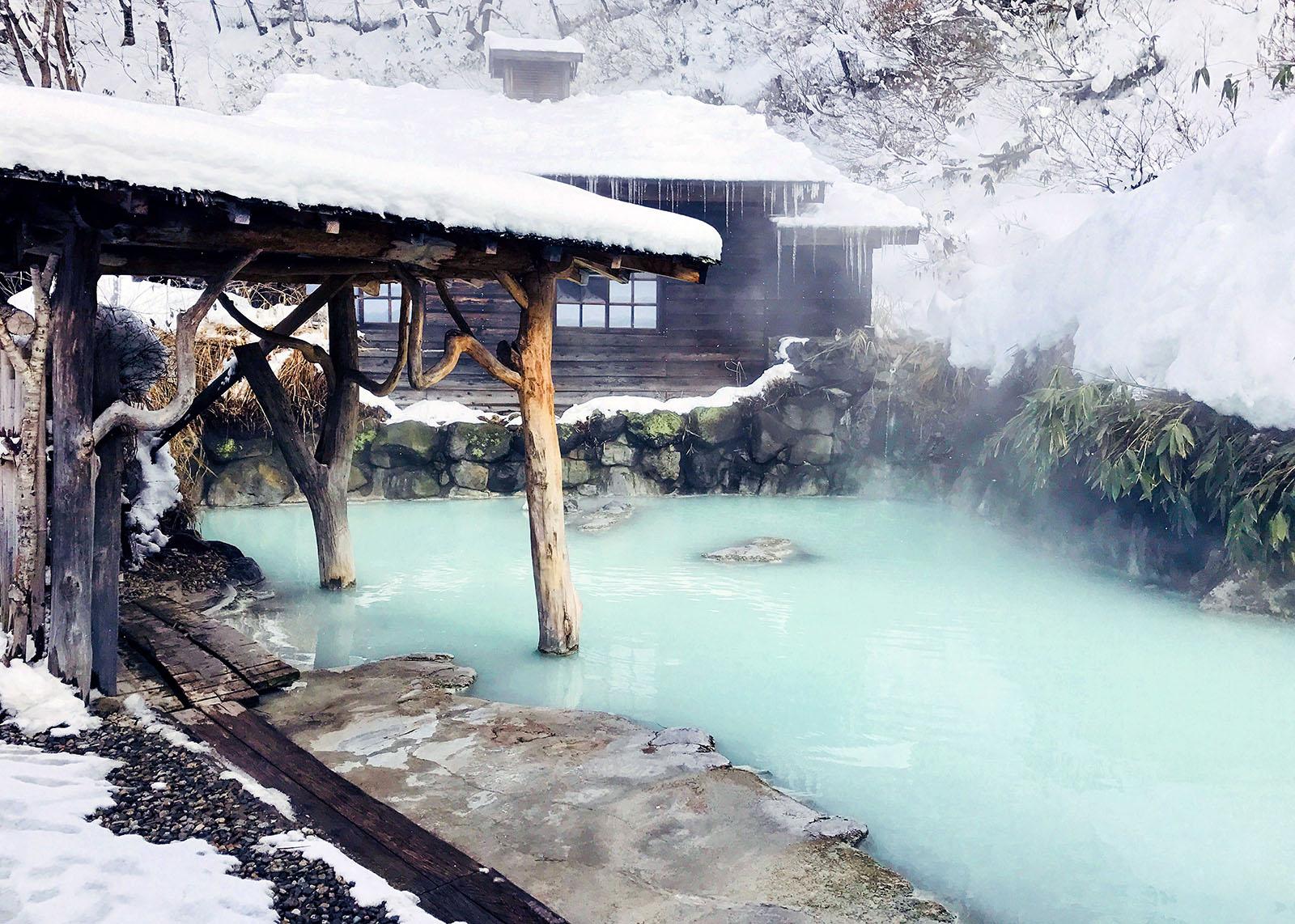 The cloudy waters of the Tsurunoyu Japanese Spa in winter, snowy weather