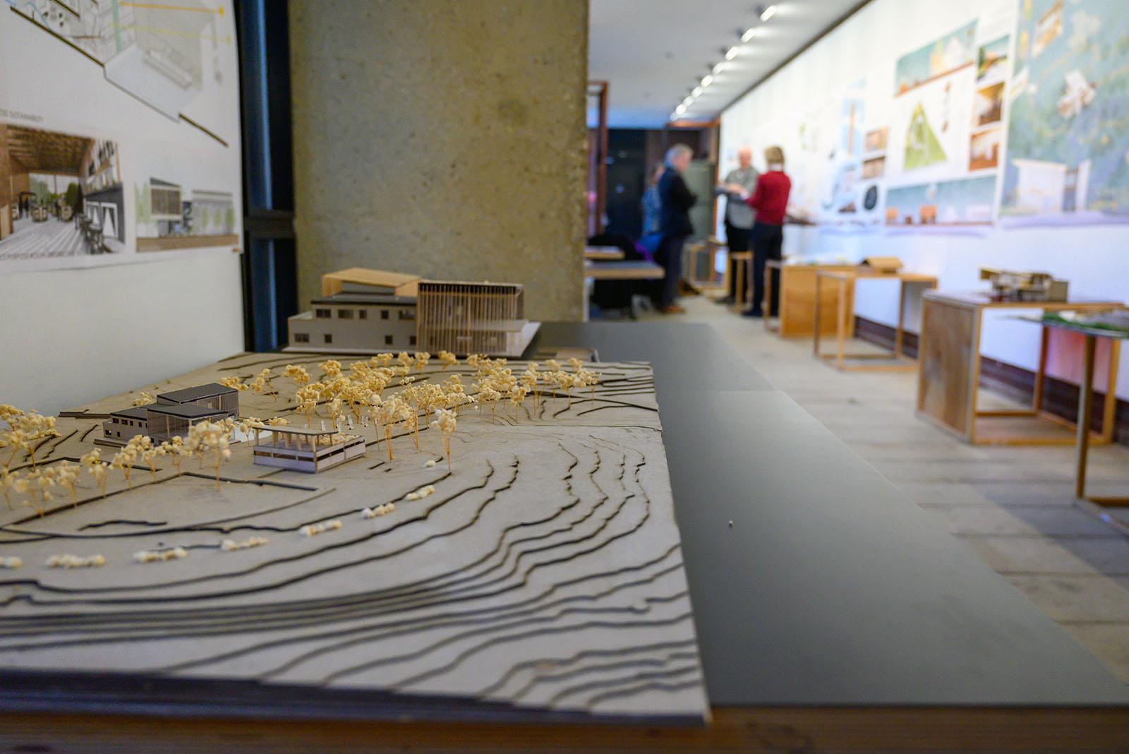 Architecture model in the foreground and people in the background