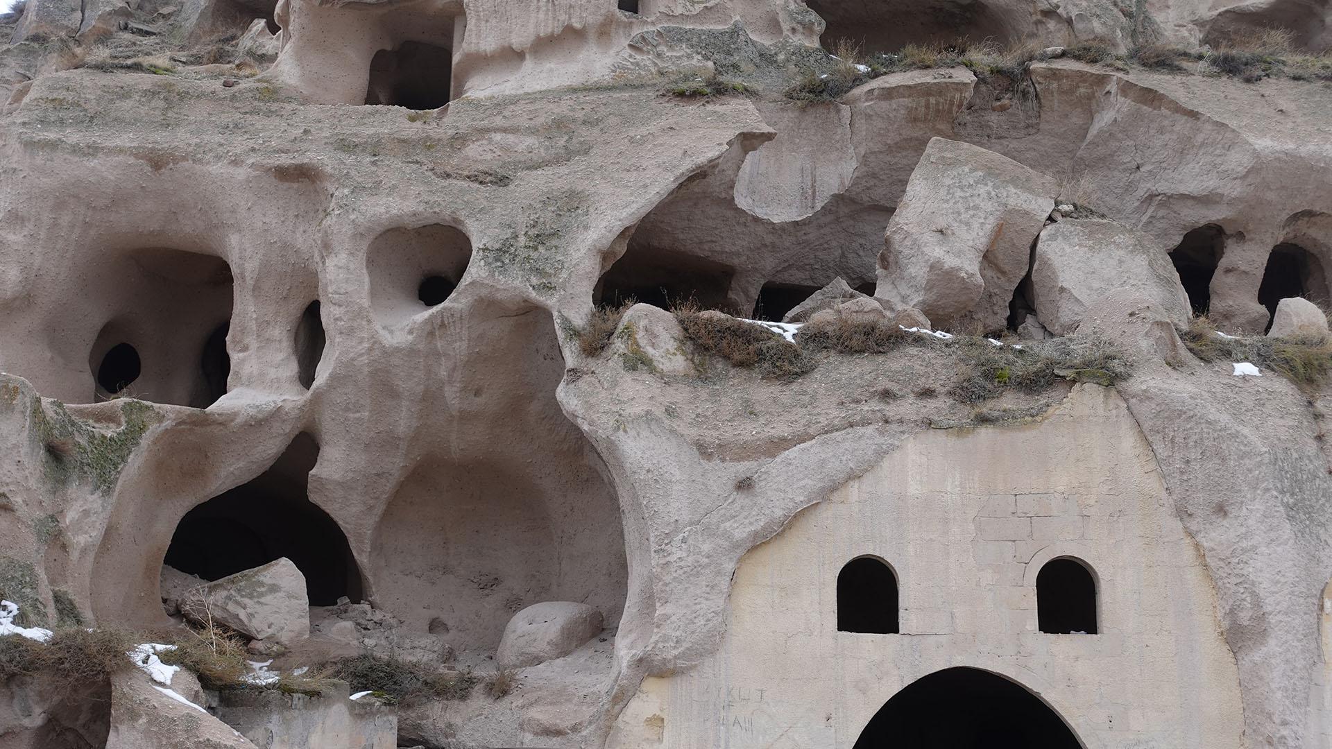 Natural and man made caves in a cliff
