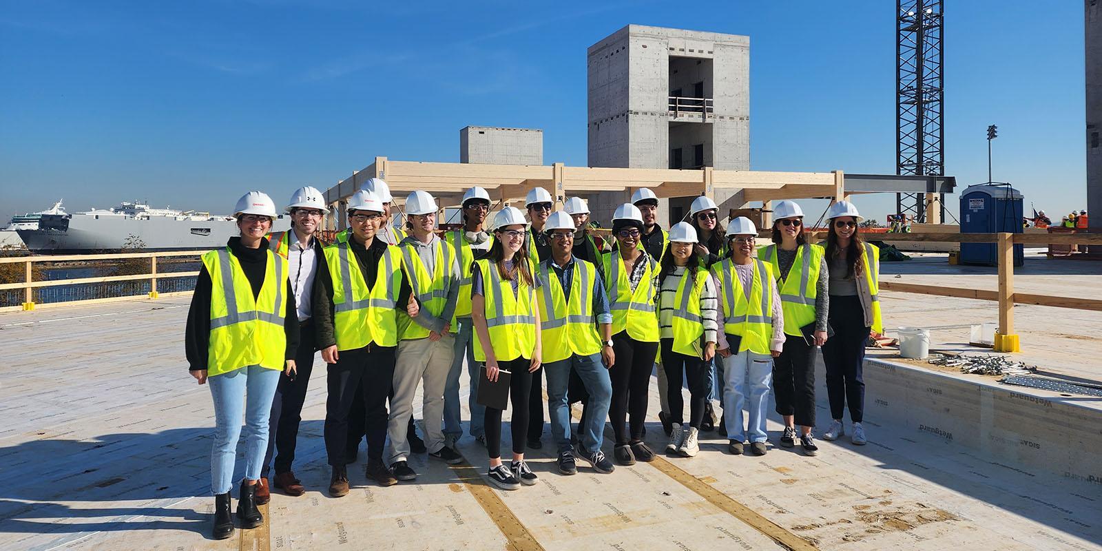 Students in hard hats and safety vests at a site visit