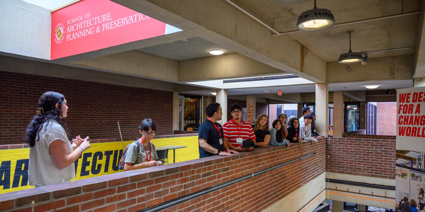 Person touring the Architecture Building with a group of students