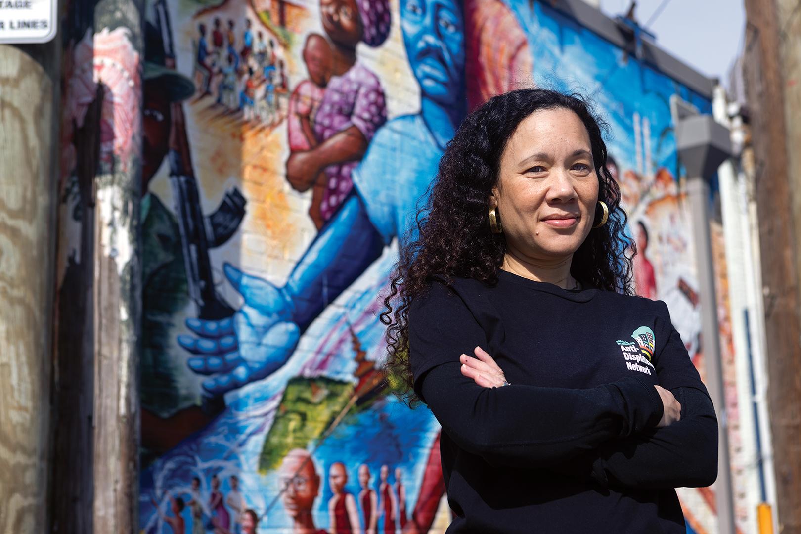 Willow Lung Amam in front of a mural
