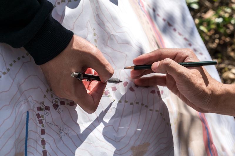 two people writing on a map