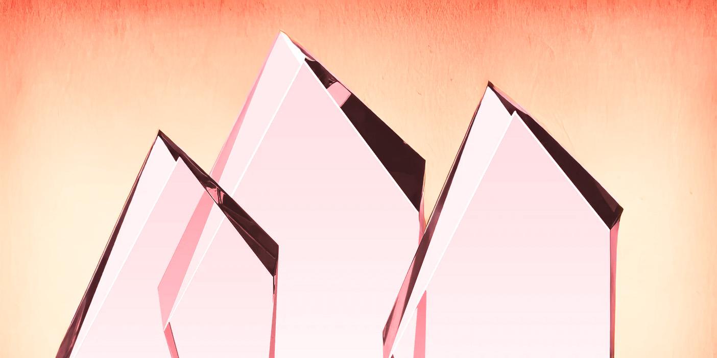 Blank crystal awards with a red tink and a textured red and yellow background