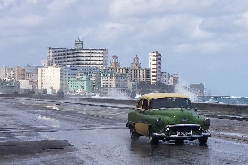 A car in the foreground and Havana, Cuba in the background