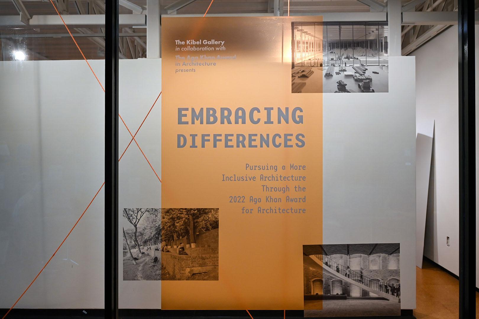 Embracing differences vinyl print on glass in orange, with overlayed black and white photos