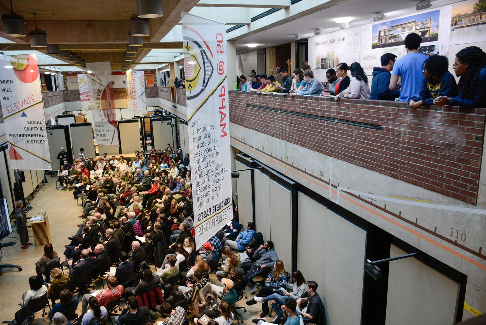 Lots of people in the Great Space and Mezzanine attending a lecture
