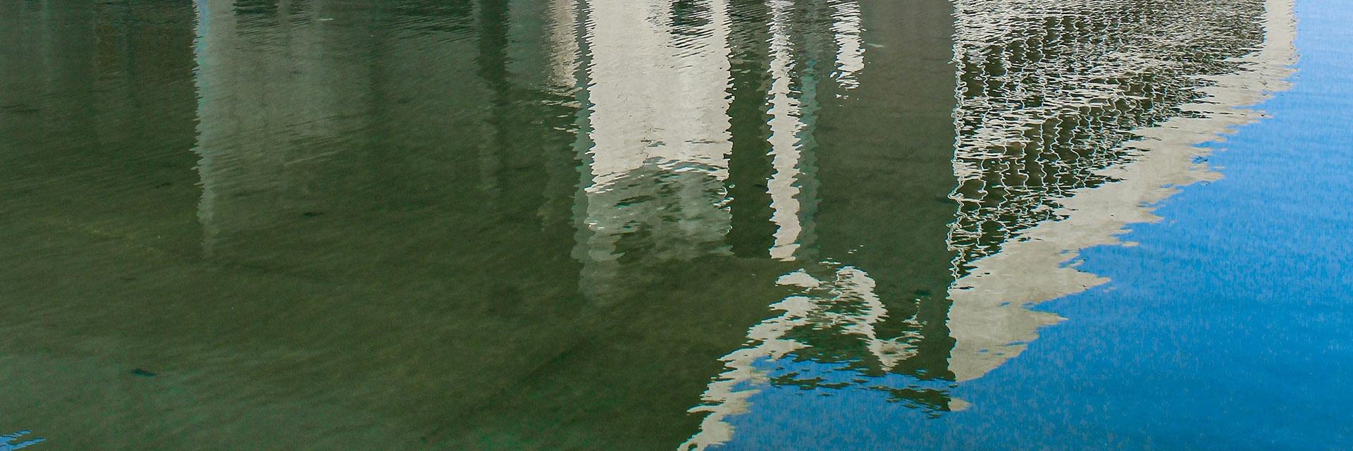 Reflection of a concrete building in the water