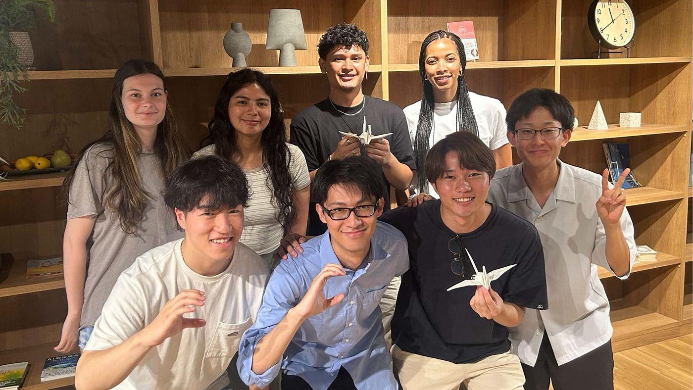 Group shot of students, some holding origami cranes