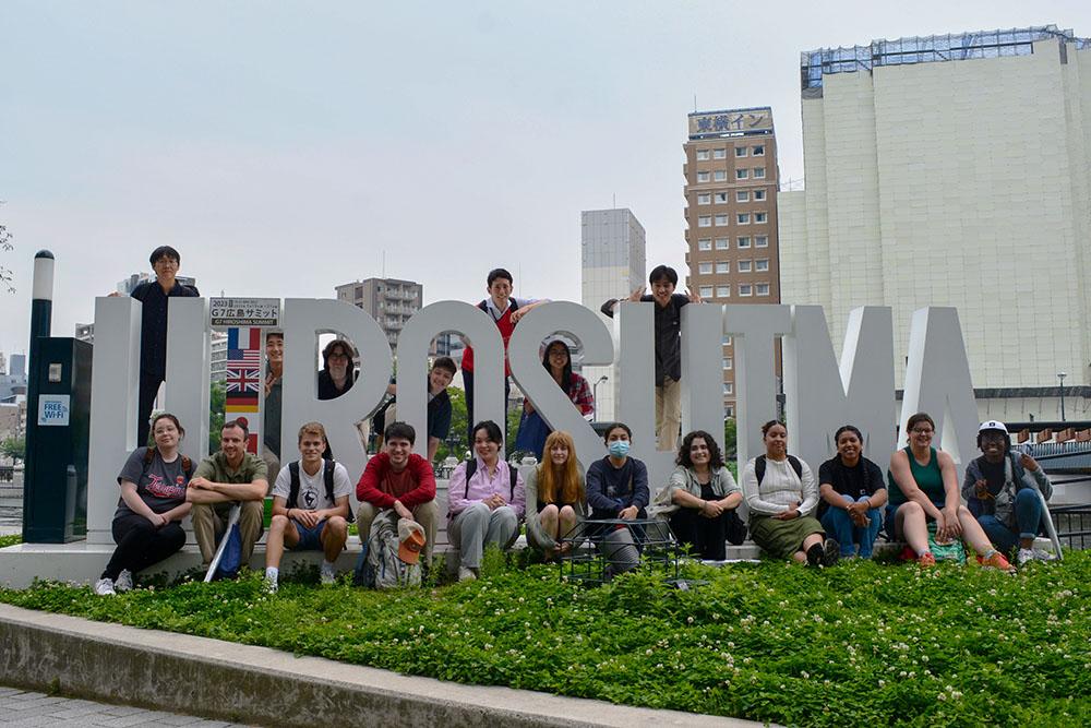 Students posing in front of a large Hiroshima sign at their Japan Education Abroad trip