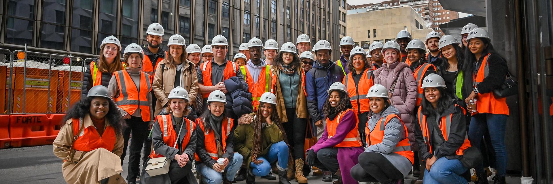 Students and faculty wearing hard hats and safety vests in New York City