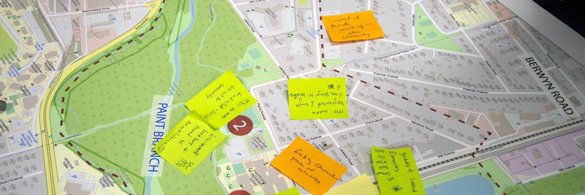 Sticky notes placed on a printed site plan of Lakeland Community