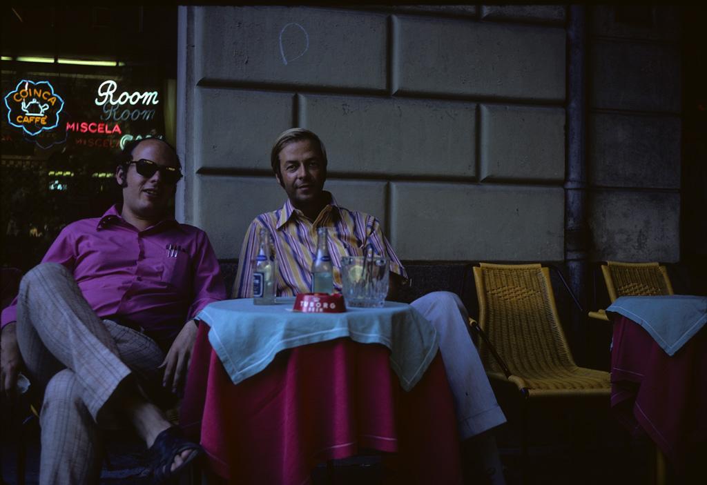 Roger Lewis and John Hill sitting at a caffe. 