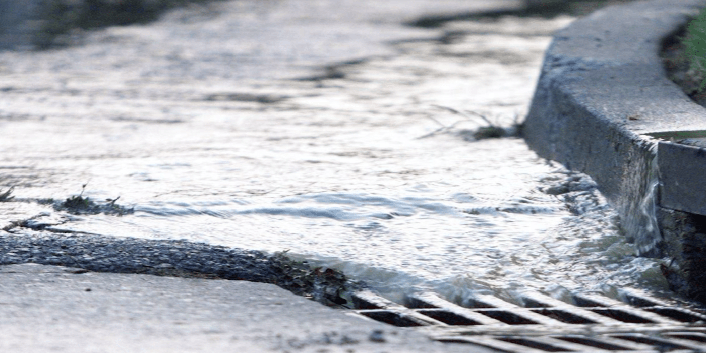 Stormwater running into a drain on the street