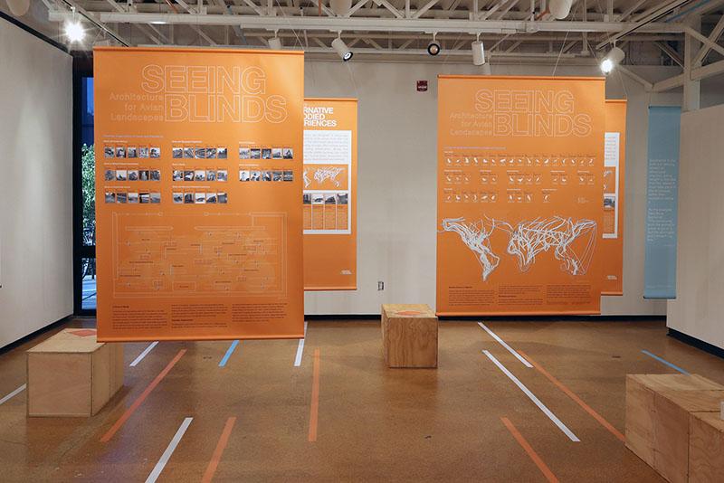 Seeing Blinds exhibit with orange banners