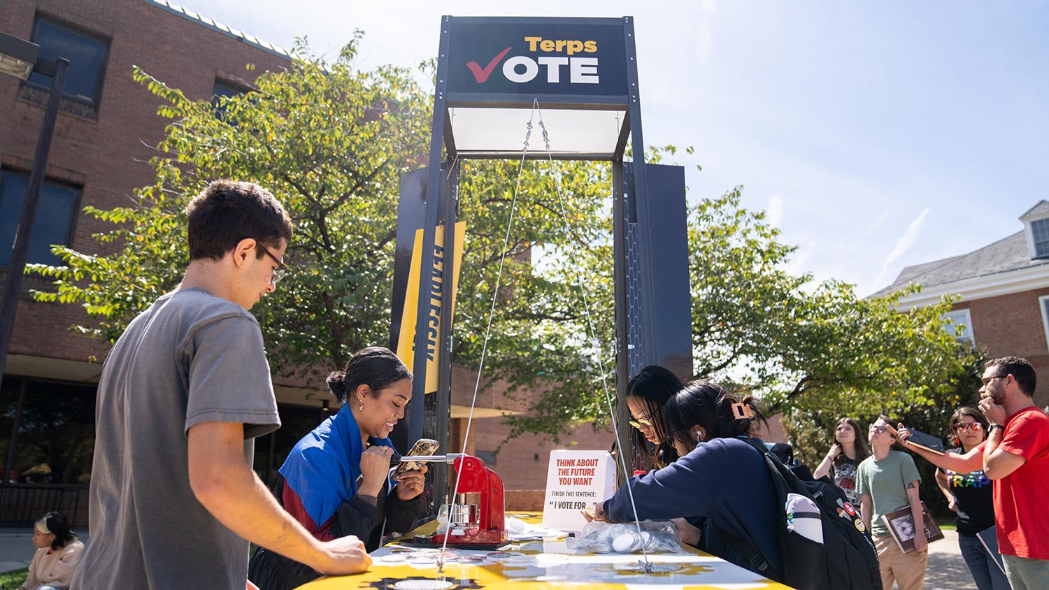 Students at the Terp Vote booth making buttons