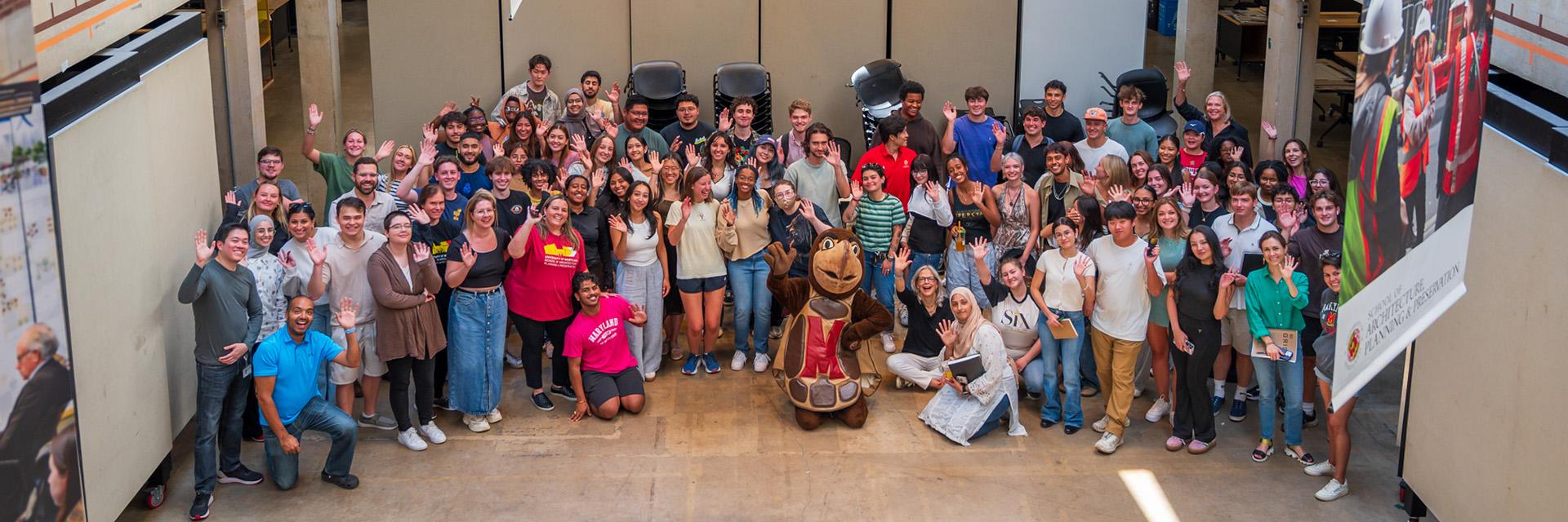Large group shot of MAPP students, faculty, staff and Testudo in the middle