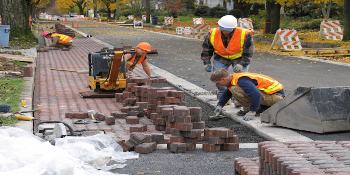 Construction workers laying bricks