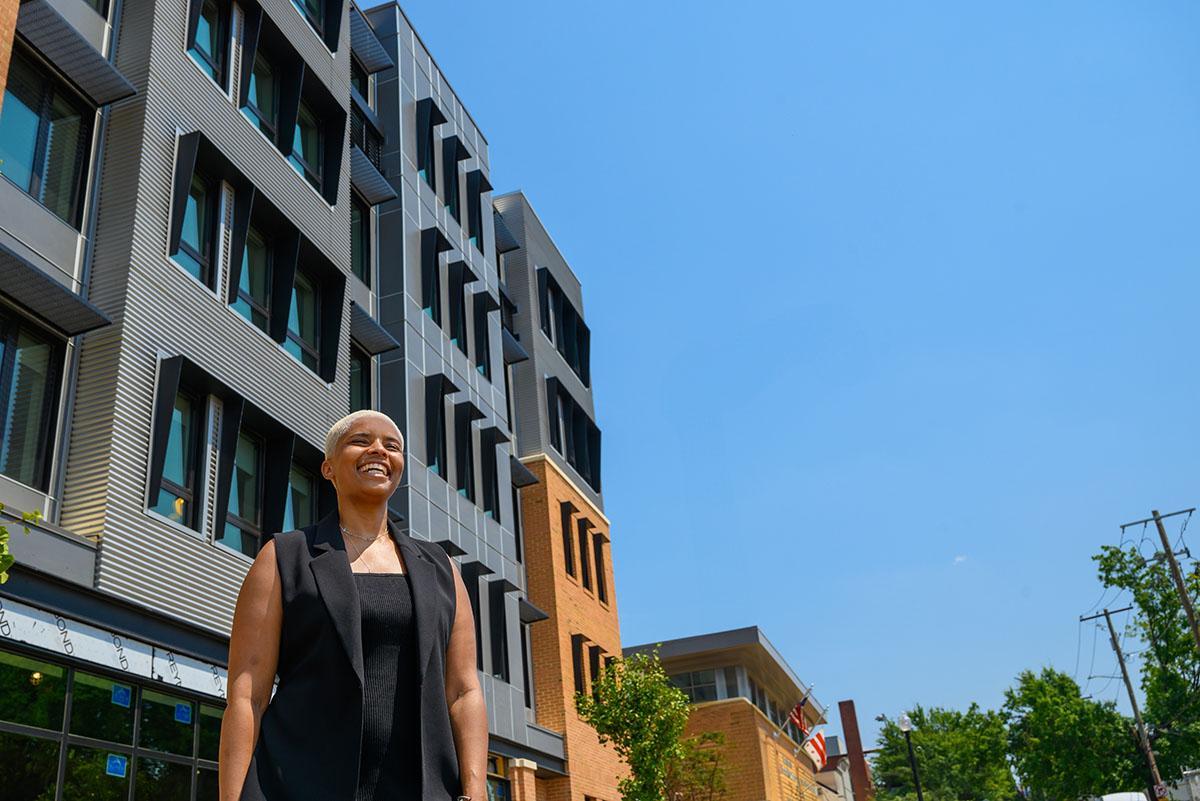 Maia Shanklin Roberts in front of a new development, with a bright blue sky