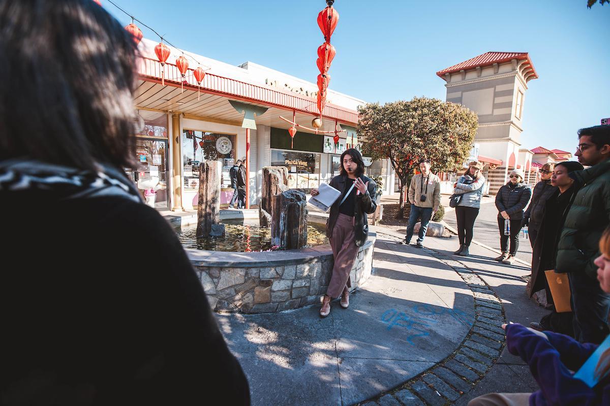 Woman talking at Eden Center with people around her