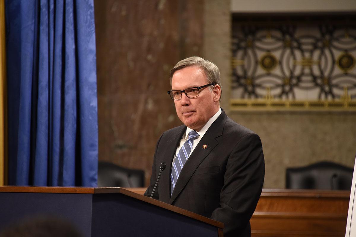 Stephen Ayers speaking at a podium