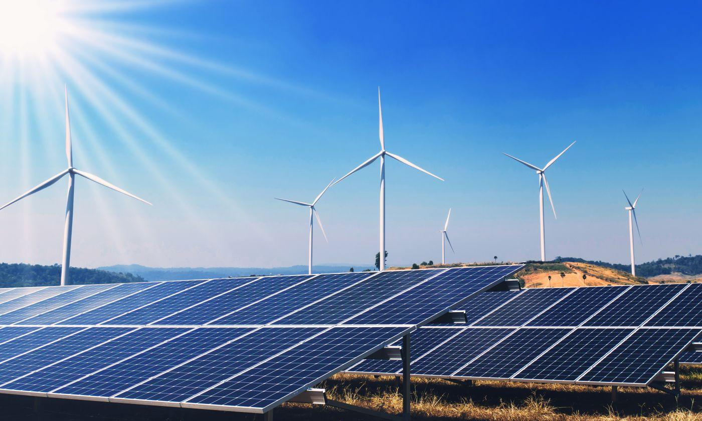 clean energy power in nature. solar panels and wind turbine