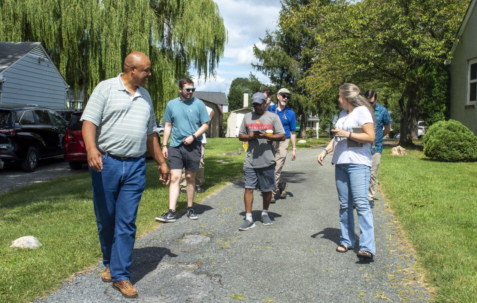 People walking in a green neighborhood