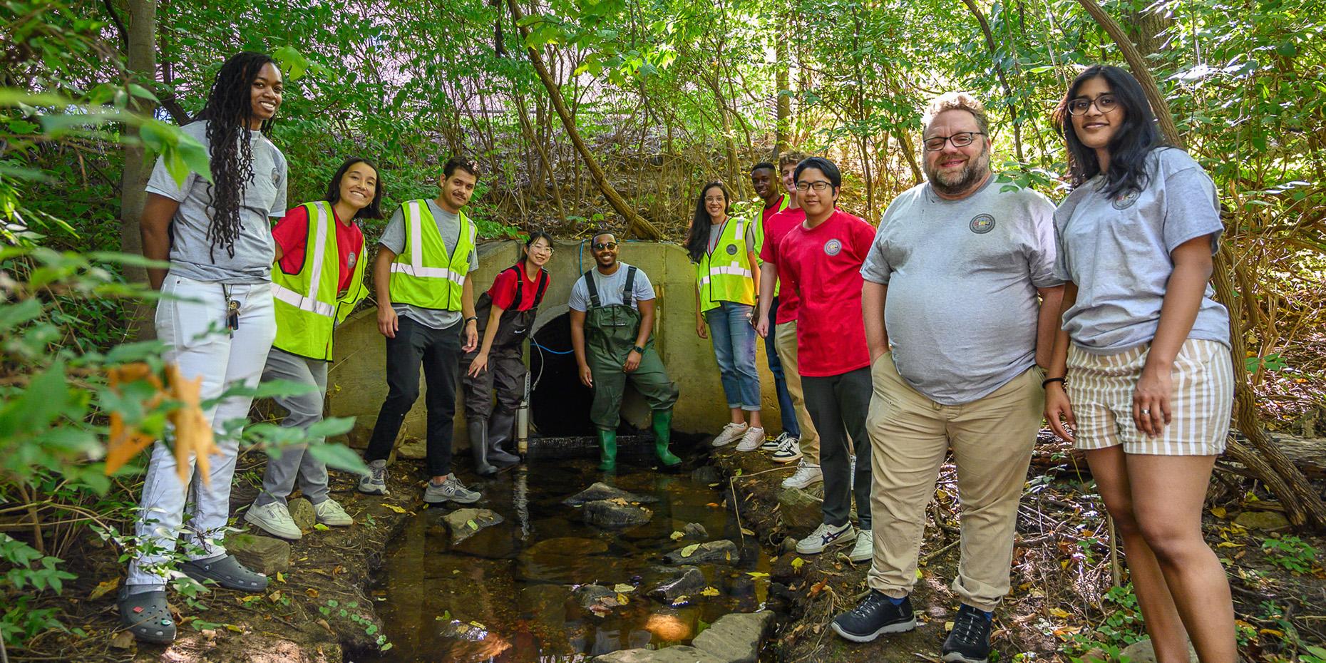 Group shot of SIRJ lab team members by a stormwater tunnel