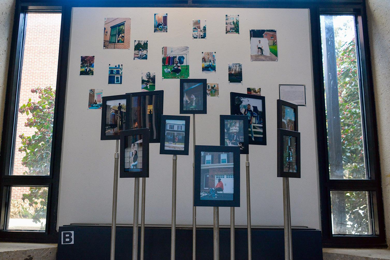 Numerous pictures in frames and on a bulletin board