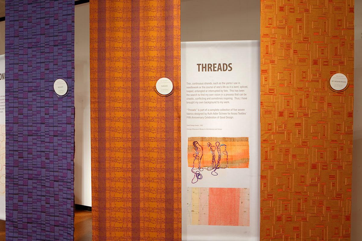 Tapestries hanging in the "Threads" exhibit