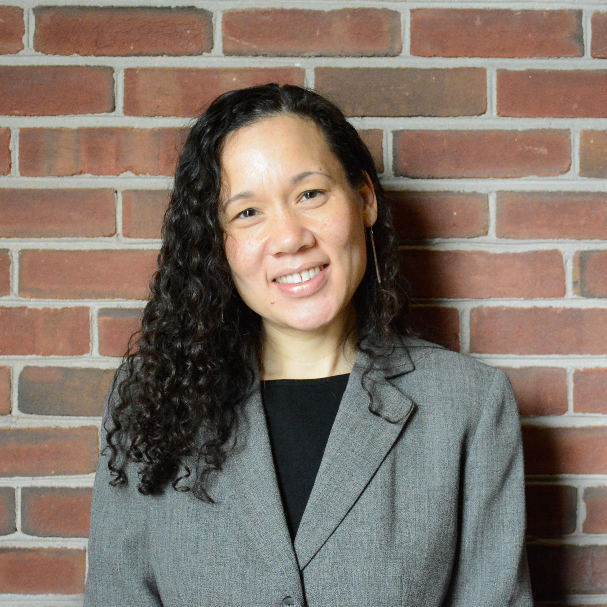 Middle aged woman smiling for professional headshot. 