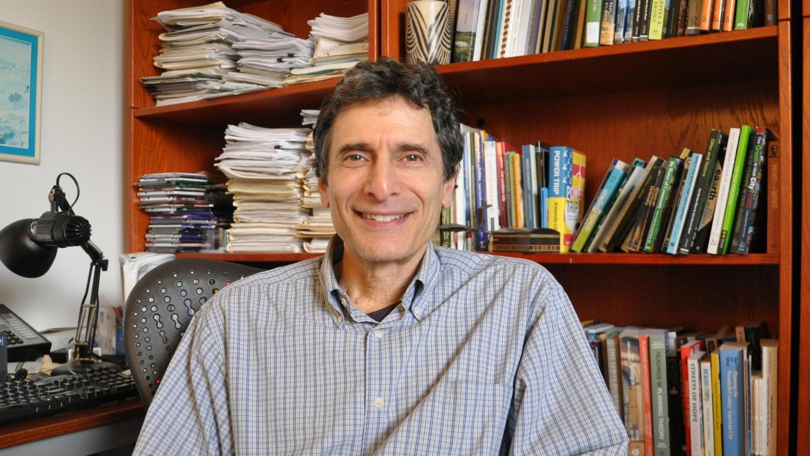 An older gentlemen smiling for a photograph. 