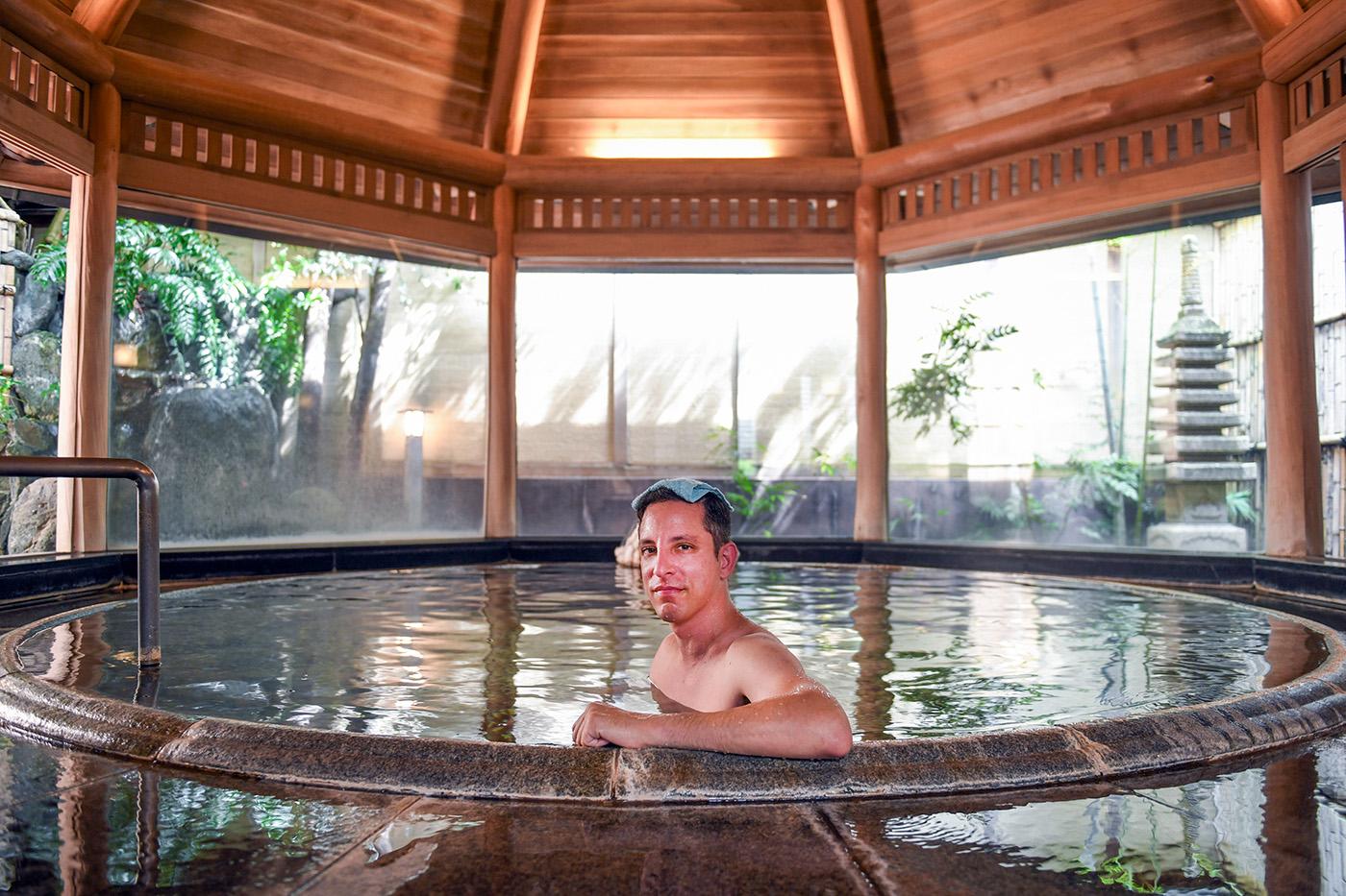 Yuval in a hot bath with a towel on his head