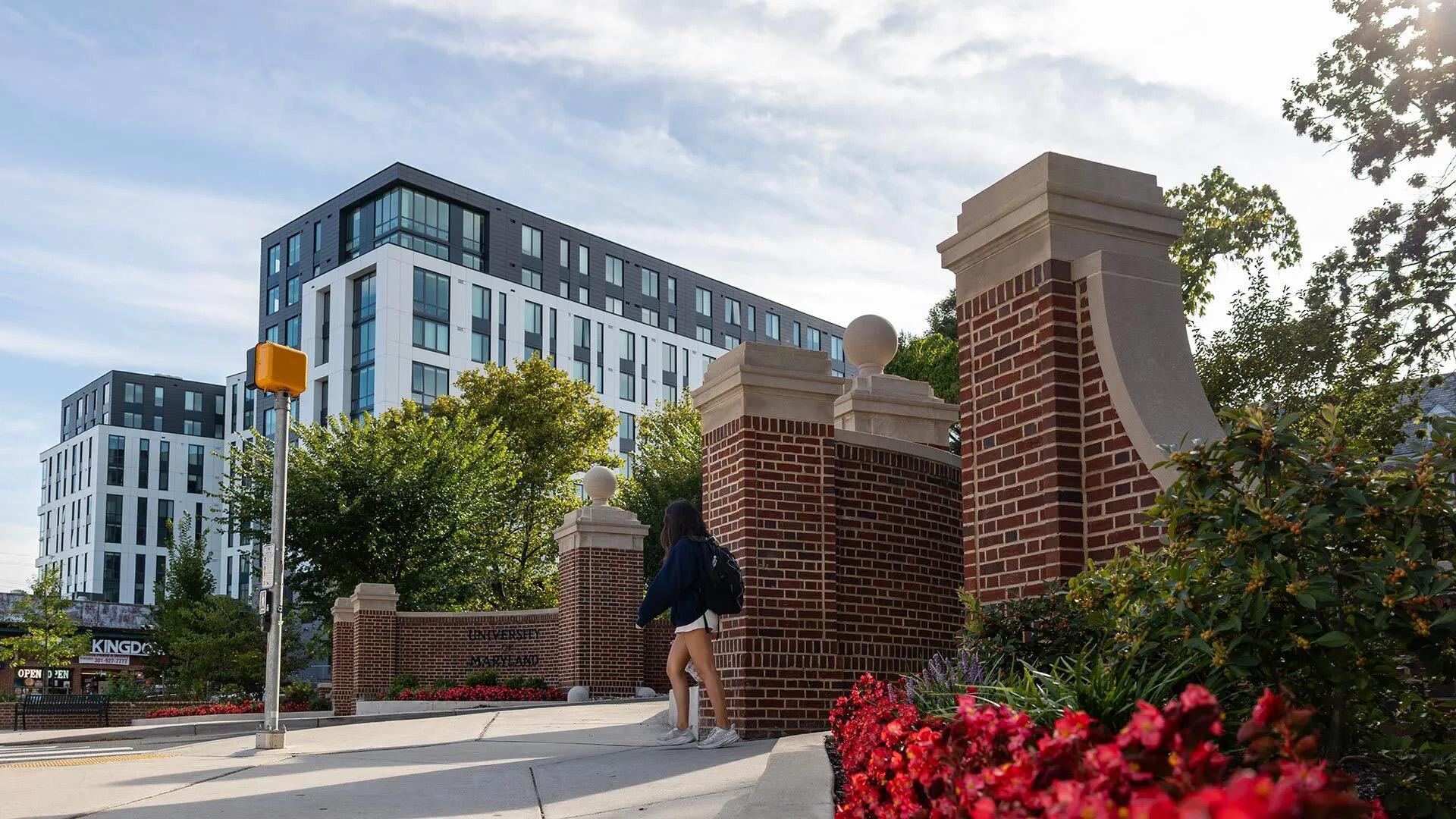 A student walking towards University of Maryland housing