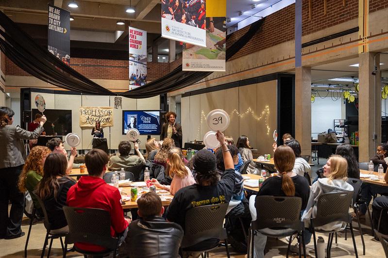 Students at a professor auction