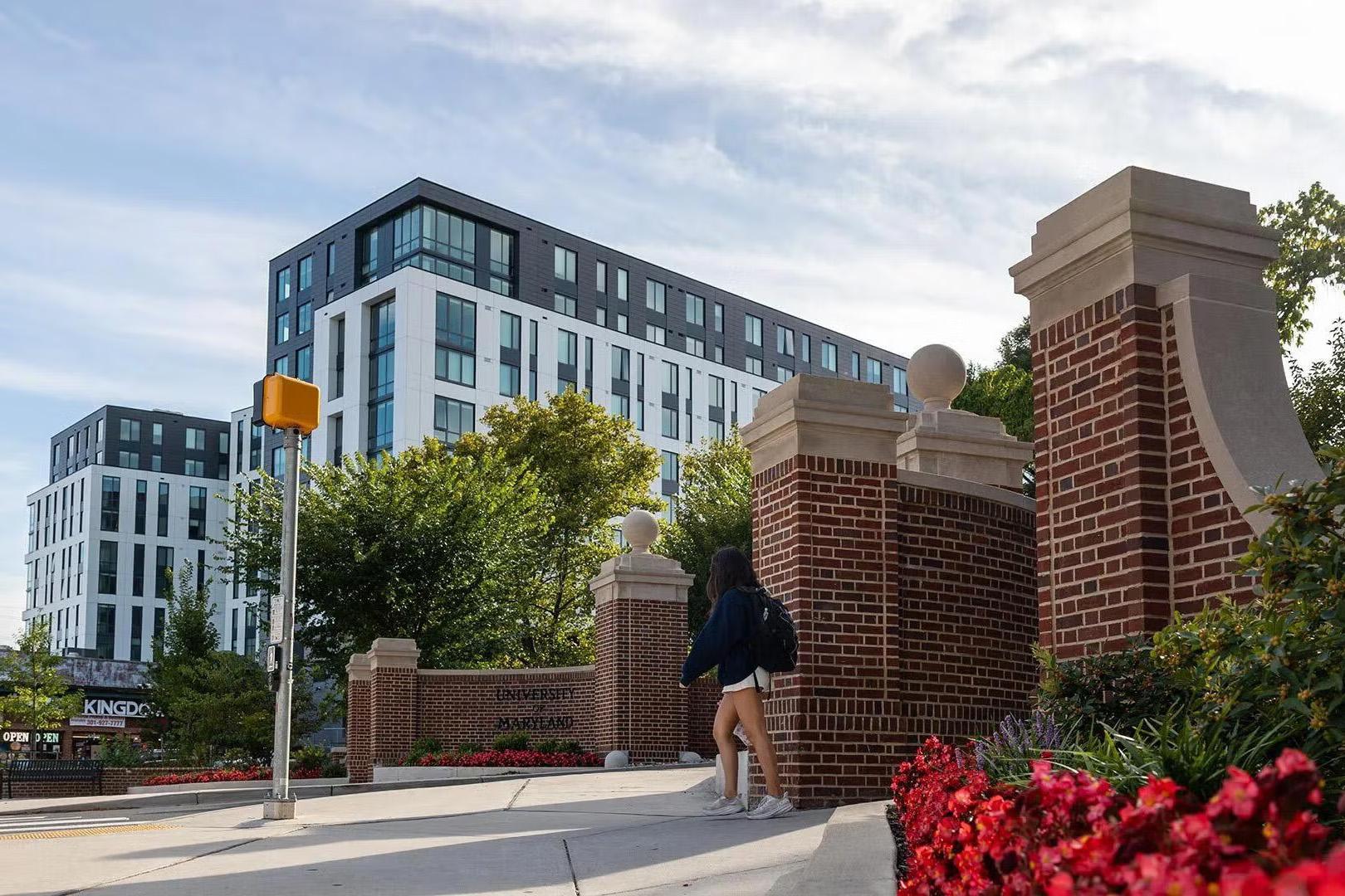 A student walking towards University of Maryland housing
