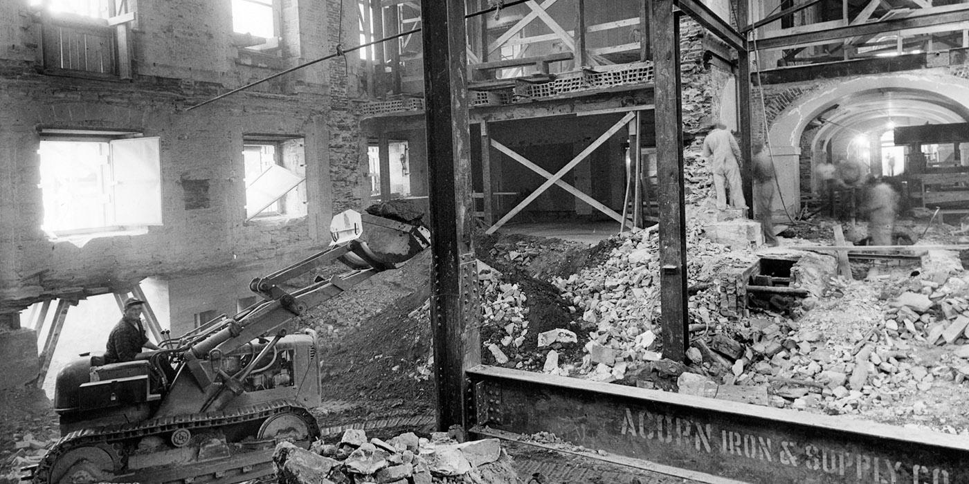 Black and white image of heavy construction at the white house with a bulldozer.