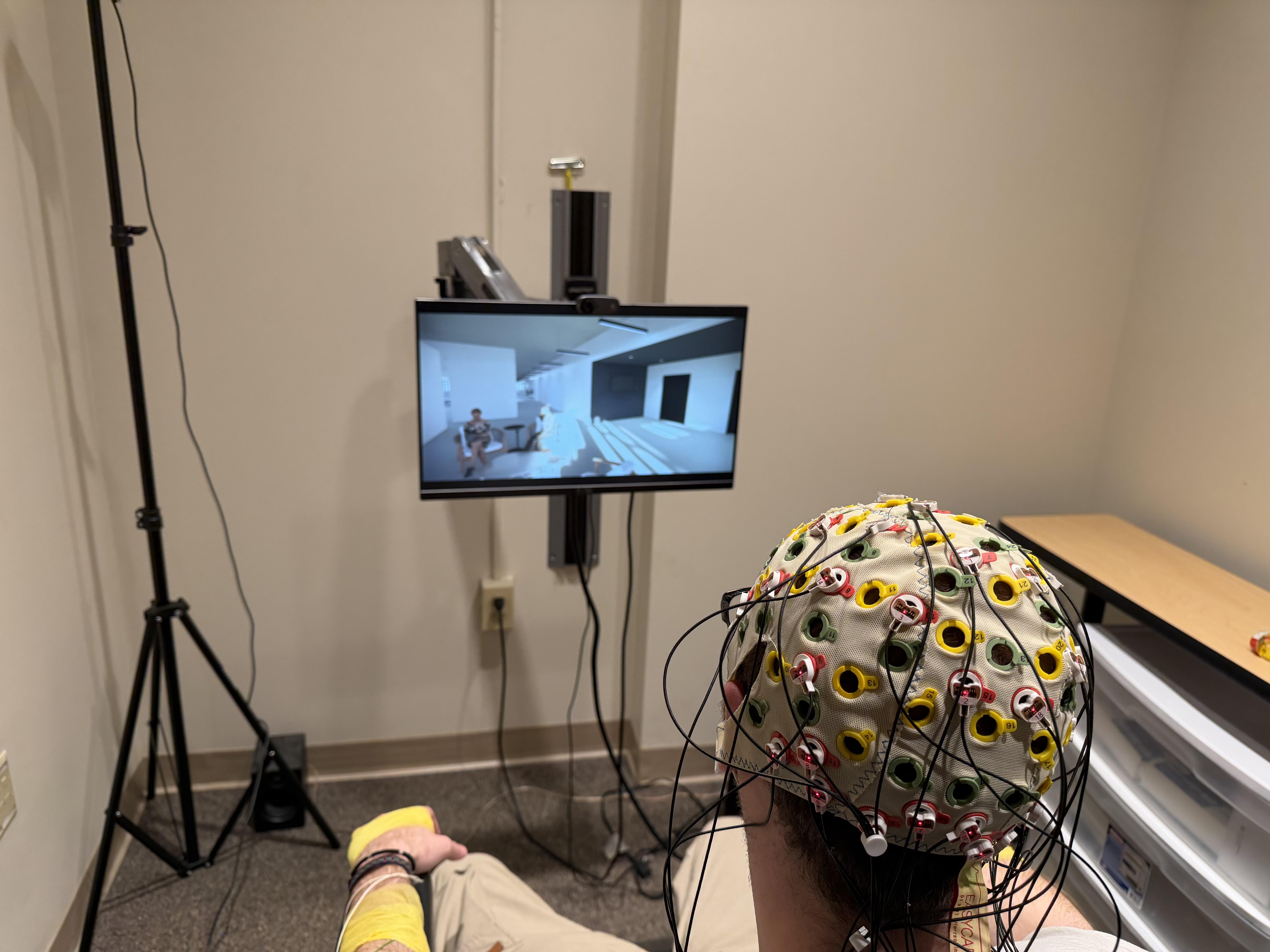 Student looking at images connected to an EEG
