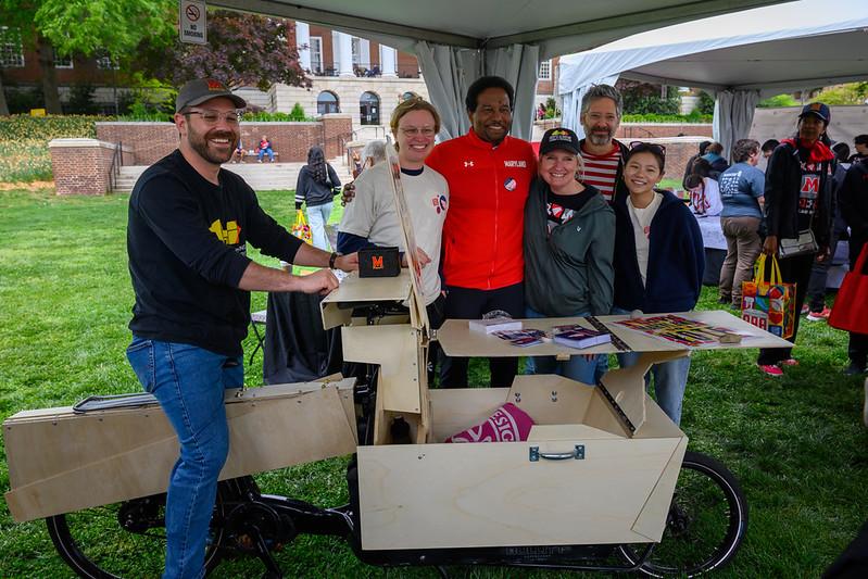 Ken Filler on the Voting bicycle with President Darryll Pines and MAPP faculty, staff and students in the background