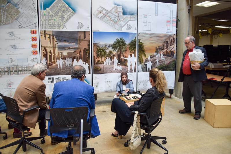 A student showing her Master of Architecture Thesis project model
